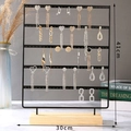Detail view of 41x30cm metal jewelry stand with wooden base showing earring storage - 5 Layers / Black