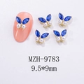 Macro detail of 3D alloy butterfly nail charm with blue crystals and white pearls - Royal Blue Pearl Gold Base Style (MZH-9783)