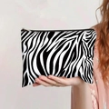 Detail of zebra print canvas makeup bag held by a model with a gold zipper closure - Black and White Zebra Print Style (jiayingpbb0152)