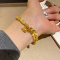 Gold plated bracelet with lucky coin charms and gourd pendant shown on wrist - Chinese Coin Gourd Lucky Bracelet