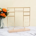 Golden iron jewelry display stand with a wooden base for necklaces and earrings - Gold