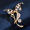 Exquisite golden butterfly brooch with sparkling crystals on dark navy background - Exquisite Butterfly