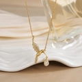 Detailed view of hummingbird pendant with white zircon inlays and golden plating - FN0139 Teardrop Charm Hummingbird