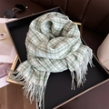 Detail of green and brown plaid cashmere-feel scarf with fringes on a luxury tray - 200x66cm / Green