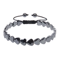 Macro shot of heart-shaped magnetic hematite beads with adjustable black braided cord strap - Faceted Heart Style (Faceted Black Magnetic Bracelet)
