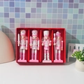 Detailed view of four pink wooden nutcracker soldiers in a red gift box packaging - 4PCS Pink Set
