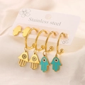 Detail of stainless steel Hamsa and blue Evil Eye charm hoop earrings set on display card - Hamsa Hand Set