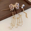 Golden butterfly hair pin with pearl tassels and rhinestones on dark wood surface - Gold Butterfly Pearl Tassel Style (84#)