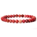Macro detail of 6mm red natural stone beads showing unique textures on an elastic bracelet - Red Emperor Stone