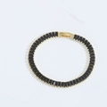 Minimalist gold bracelet featuring a continuous inlay of elegant black rectangular stones - Black