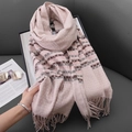 Pink cashmere-like scarf with gray and brown stripes and fringe on a gray sofa - Light Pink