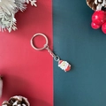 Christmas keychain featuring a classic Santa Claus charm on a festive red and green background - Santa Claus