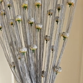 Close-up of silver string curtain with decorative white and yellow flower ornaments - Silver Gray