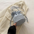 Light blue drawstring bucket bag with glossy satin finish and golden metallic tips - Blue