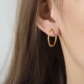 Minimalist 18k gold hoop earring with a polished finish worn on a model's ear - Gold 2.1cm