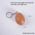 Realistic brown egg-shaped keychain made of plastic with a silver metal keyring - Keychain / Stewed Egg