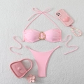 Detailed view of pink halter bikini set with gold ring ornament on soft plush background - S / Pink