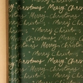 Dark green Christmas wrapping paper roll with gold Merry Christmas print and snowflakes - Irregular Merry Christmas