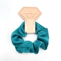 Cyan satin scrunchie displayed on a pink diamond-shaped card for wedding parties - Teal