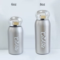 Detail view of 6oz and 8oz silver stainless steel insulated bottles with brand logo - 180ml (6oz) / Stainless Steel Silver