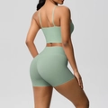 Detail view of mint green high-waist yoga shorts and strapless back sports bra set - Basil Green