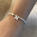 Beaded bracelet with white frosted beads, golden heart, and letter N shell charm - Letter N