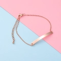 Detail view of a rose gold curved bar bracelet with adjustable chain and lobster clasp - Rose Gold