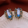 Macro shot of handmade wire-wrapped blue crystal earrings with intricate gold weaving detail - Sky Blue Hand-Woven Style (8# Silver Needle)