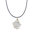 Close-up of raw crystal pendant wrapped in gold wire with a black cord necklace - White Crystal