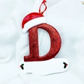 Macro detail of red sequined letter D Christmas ornament with Santa hat and holly - Letter D