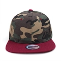 Close-up of camouflage snapback cap with burgundy flat brim and quality seal sticker - Wine Red Brim Camouflage