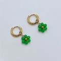 Detail view of gold hoop earrings with green beaded flower charms on white background - Avocado Green