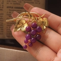 Vintage style gold grape brooch with purple gemstones and detailed leaf texture - Purple