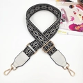 Detail of adjustable black and white diamond pattern jacquard strap with gold hardware - Gold Buckle / Black with White Border + White Leather