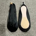 Detailed view of satin ballet slipper case with zip closure and anti-slip sole texture - Black