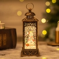 Vintage bronze Christmas lantern with snowman snow globe and glowing warm light bokeh - 2024 New Hollow Square Snowman Lamp