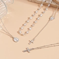Detail view of silver layered necklace set with cross and oval saint portrait pendants - Four-Piece Cross Virgin Mary Style / Silver