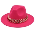 Macro detail of wide brim fuchsia fedora hat featuring a chunky gold chain accessory - Rose Red