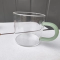 Clear borosilicate glass teacup featuring a minimalist light green handle detail - Green Jade Handle