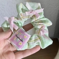 Light green checkered scrunchie with pink ribbon bows and handmade label detail - Green Plaid Bow