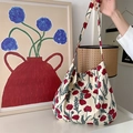 Close-up of canvas shoulder bag featuring red floral print in an artistic lifestyle setting - Poppy