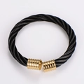 Close-up of black cable wire bracelet with gold-plated threaded end caps on white background - Black with Gold Caps