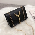 Vintage black crossbody bag with golden deer head emblem and metal tassel detail - Black
