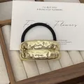 Golden punk style metal ponytail holder with irregular hammered texture and black band - GD428 Gold Wrinkle Double Arc