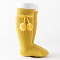 Knee-high rib knit baby socks in bright yellow with cute bows and fuzzy pom-poms - Yellow