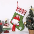 Green Christmas stocking with 3D Santa Claus doll and festive decorations - Long Legs Santa with Bell