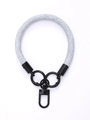 Close-up of light blue braided wrist strap with black metal rings and quick-release clip - Pearl Blue
