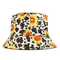 Bucket hat featuring a stylish combination of black white cow print and sunflowers - Sunflower