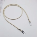 Detail of cream PU leather bag strap featuring silver swivel hooks and fine stitching - Beige + Silver Hook