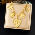 Gold plated stainless steel necklace with textured heart pendants on a jewelry box - Large Heart Spiral Relief Style (N3641)